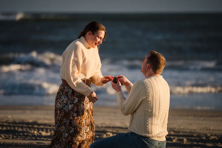 Louis proposing to Sarah on the beach