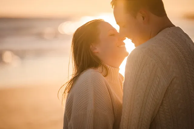 Sarah and Louis on the beach at sunset